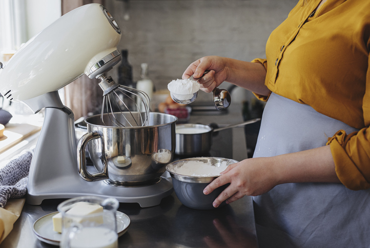 Woman Making Whipped Cream On A Kitchen Counter At Home